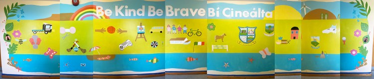 A photo of a colourful school mural featuring landscape and things the children enjoy or have noticed around thier local area.